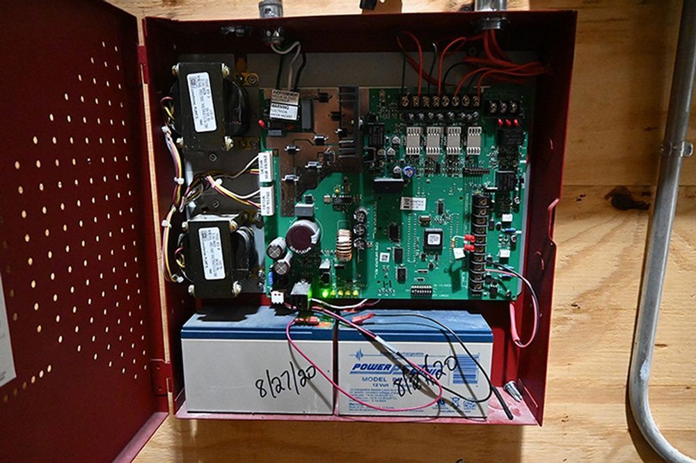 A red box with a motherboard and a battery inside of it