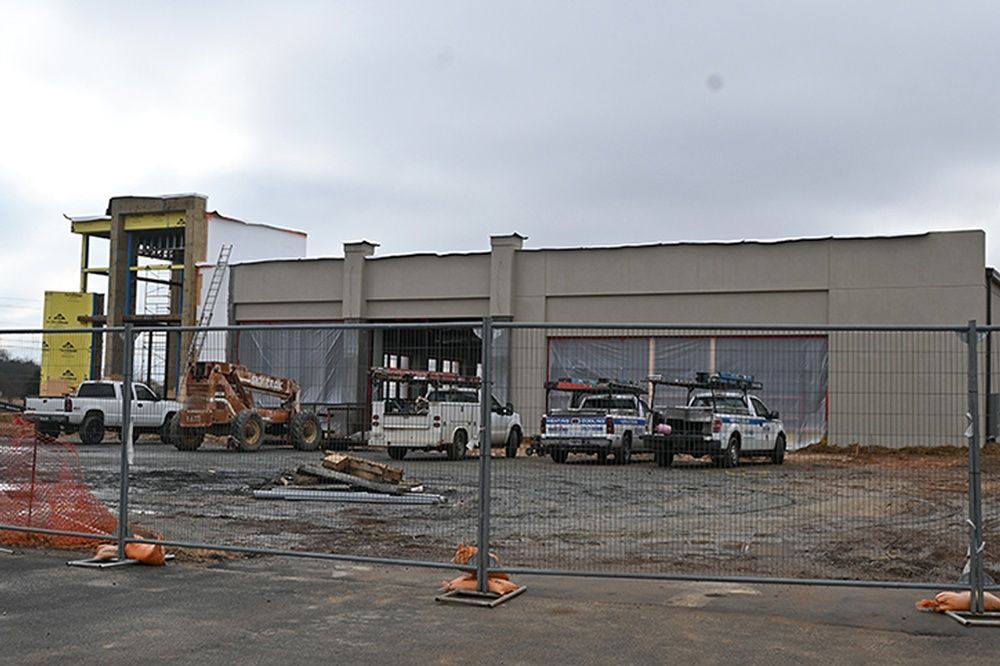 A building under construction with a fence around it