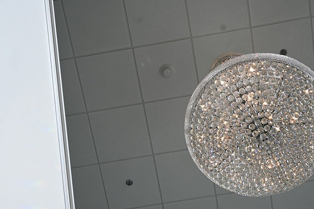 A large chandelier is hanging from the ceiling of a room.