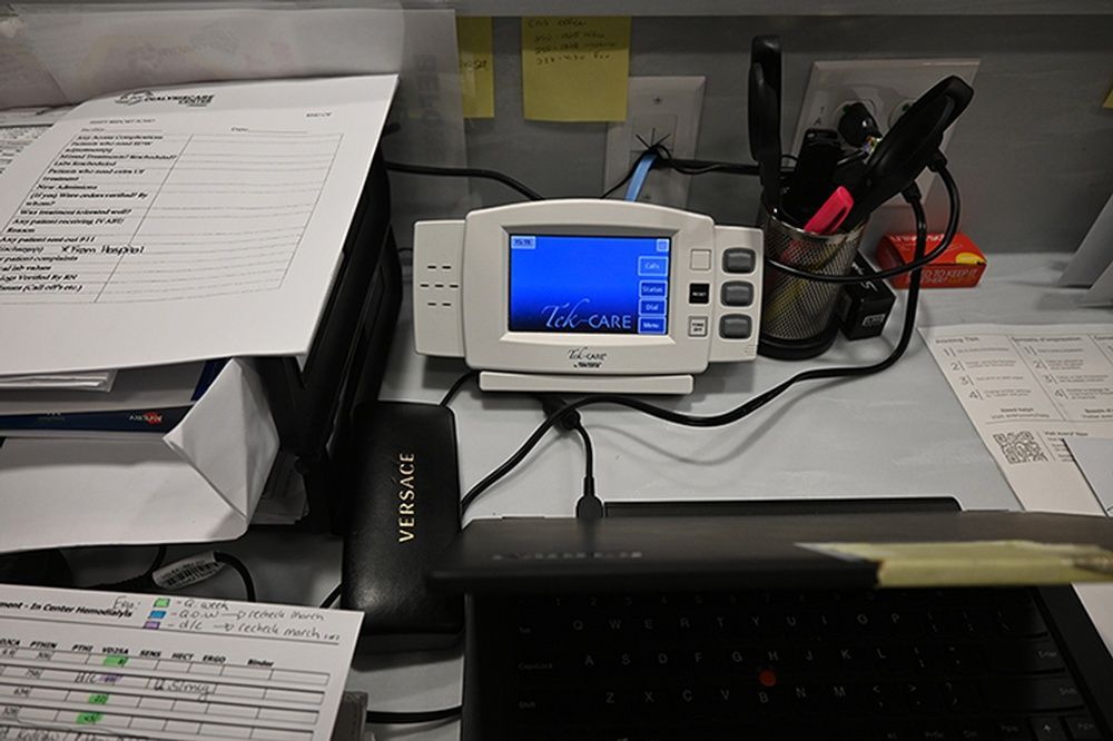 A desk with a phone that says next on it