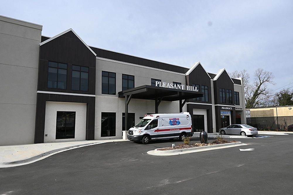 An ambulance is parked in front of a large building