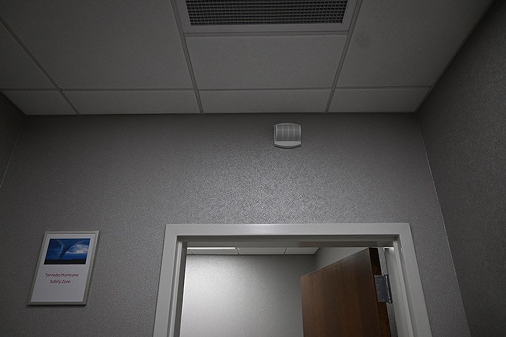 A room with a door and a ceiling fan.