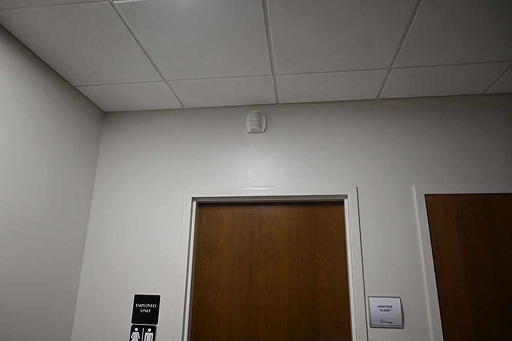 A room with a wooden door and a white ceiling