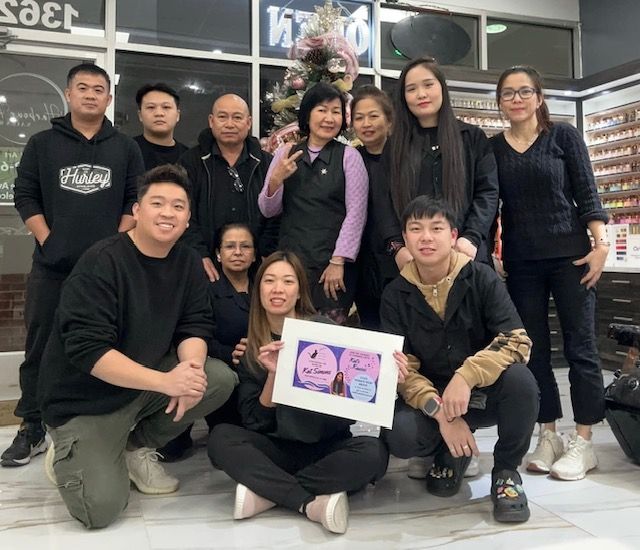 A group of people are posing for a picture in a store.
