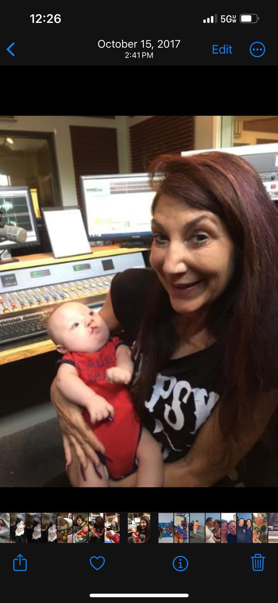 A woman is holding a baby in her arms in a studio.
