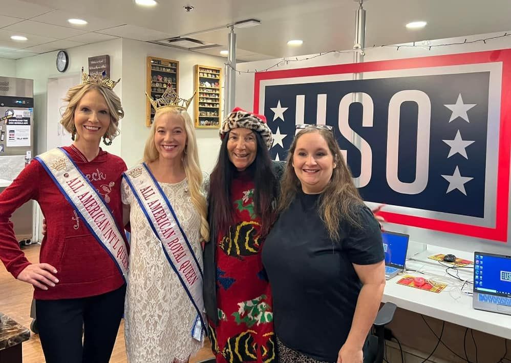 A group of women are posing for a picture in front of a usa sign.