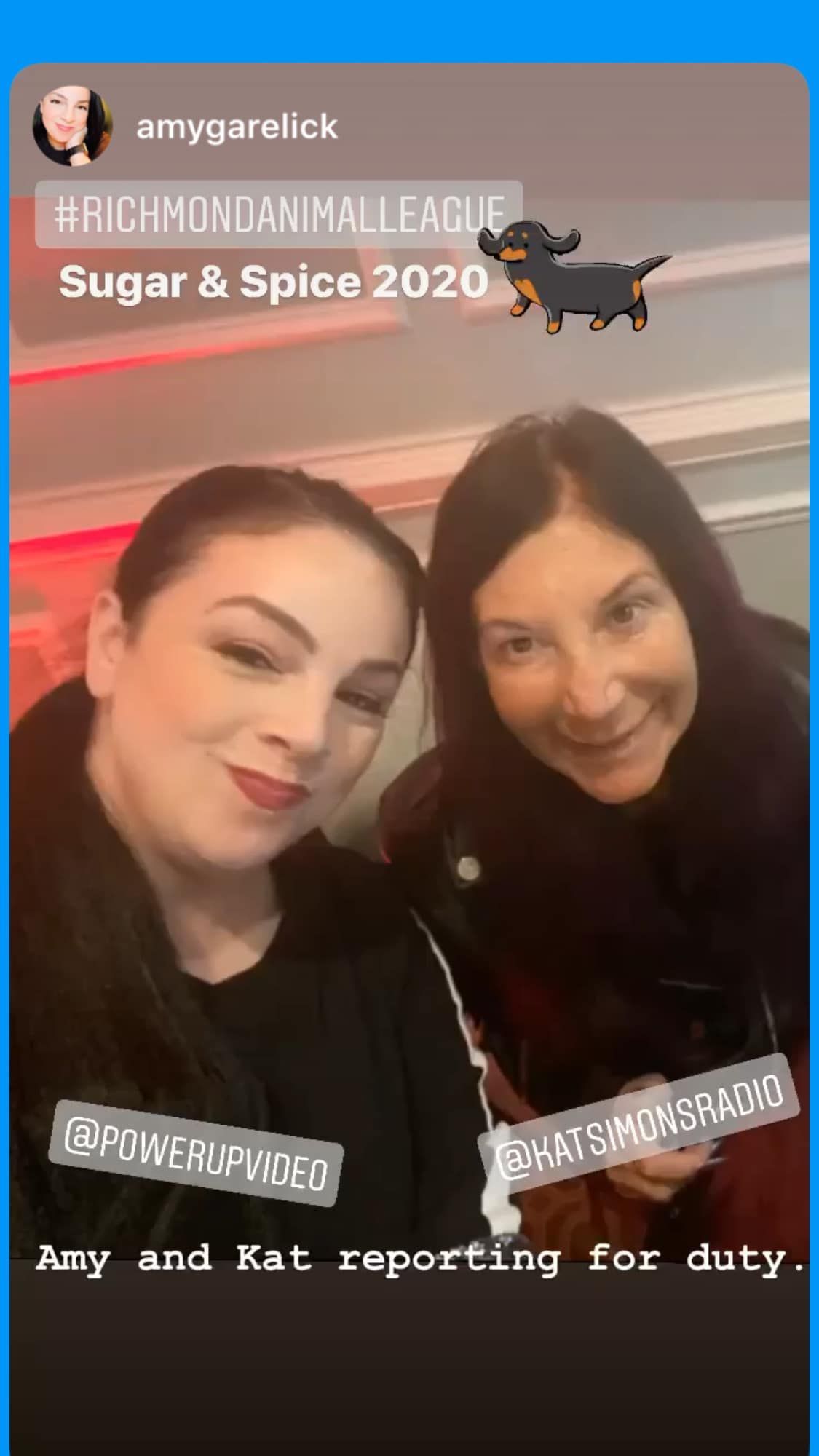 Two women are standing next to each other and smiling for a picture.