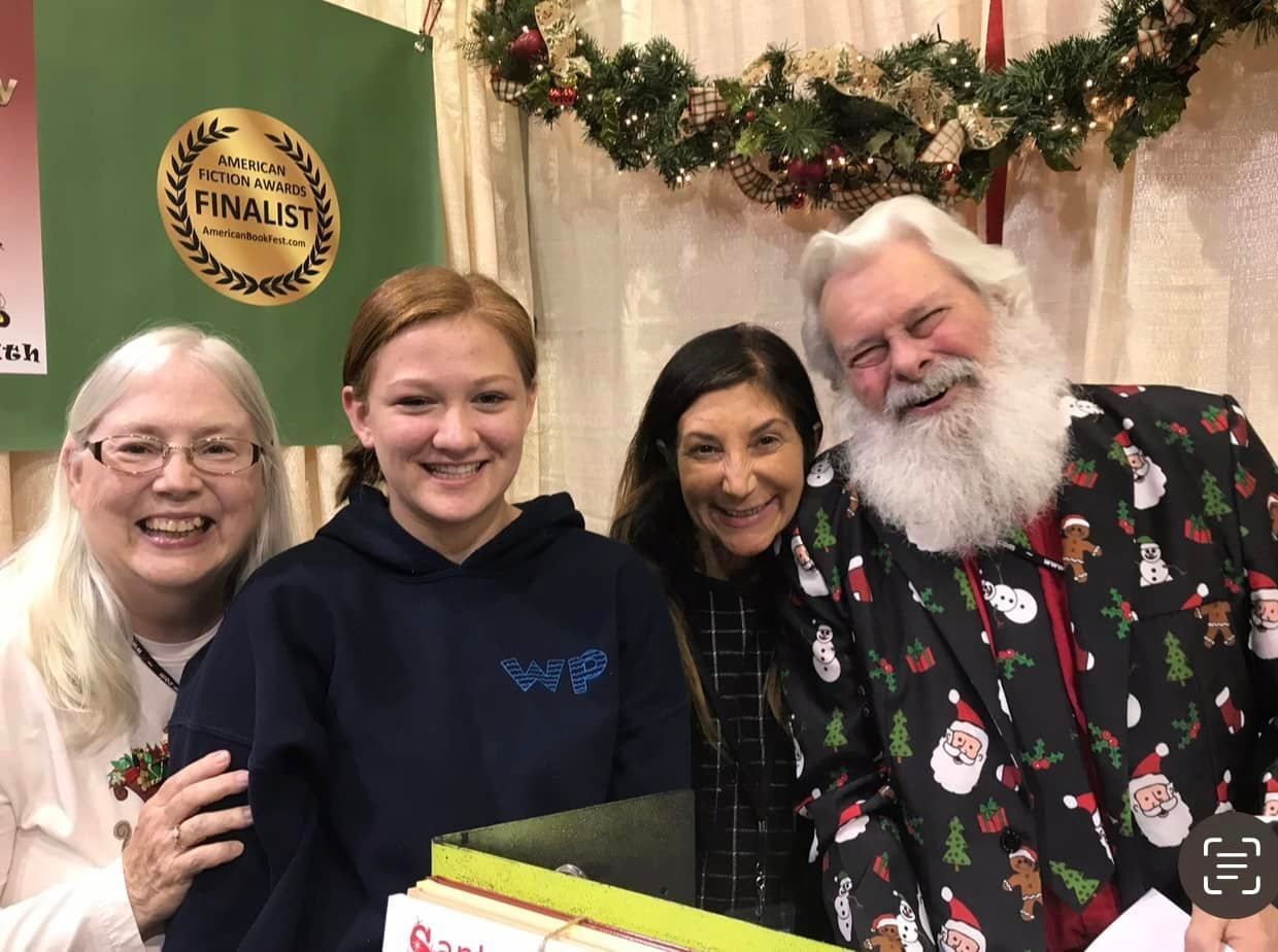 A group of people are posing for a picture with santa claus