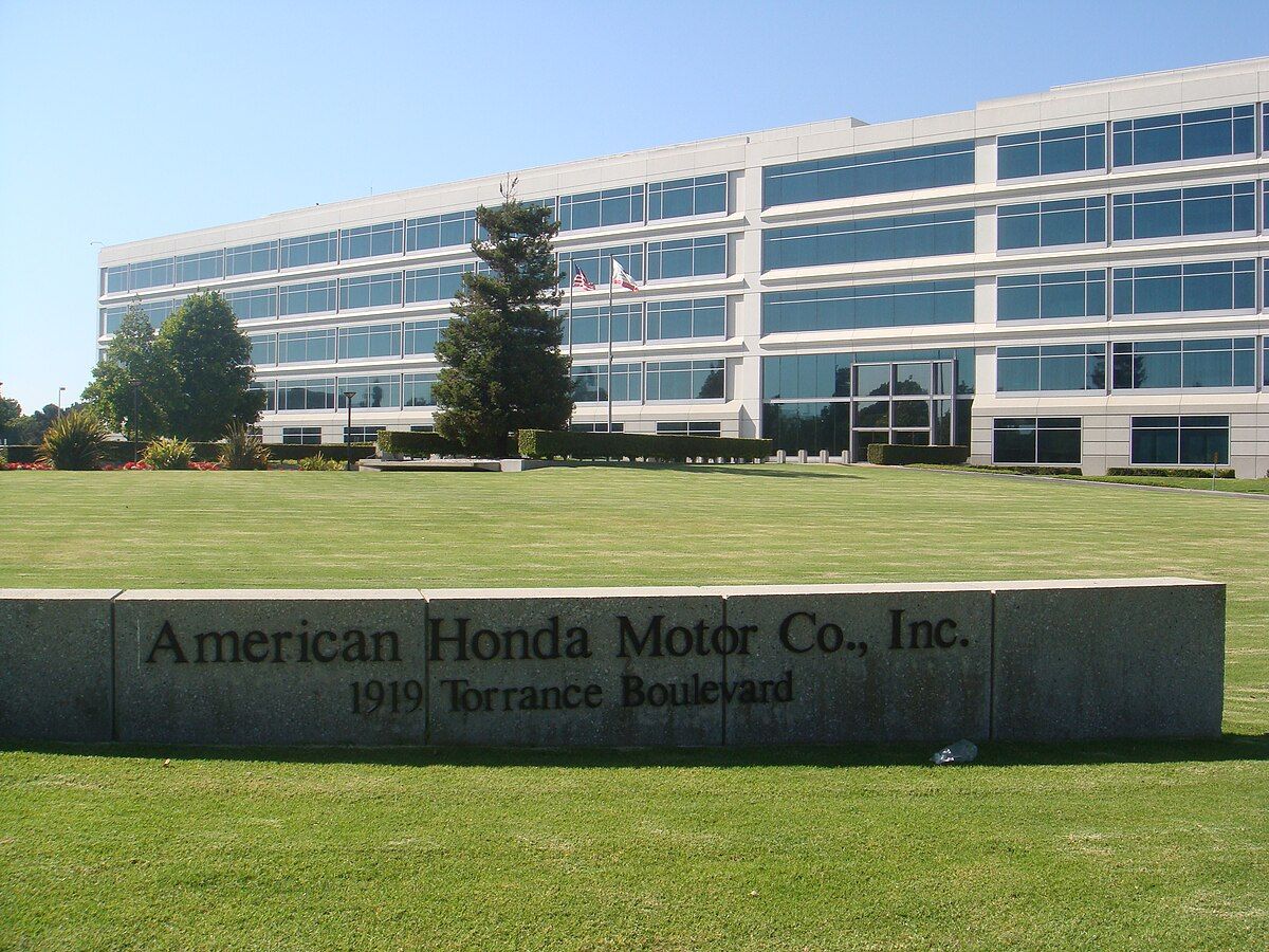American Honda Motor Co. Inc. building in Torrance, California, with sign on a grassy lawn.