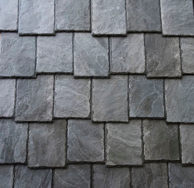 Gray slate roof tiles arranged in a staggered pattern.