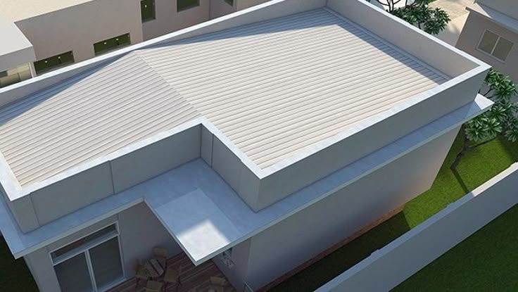 Overhead view of a modern building with a white tiled roof and a flat, raised section.