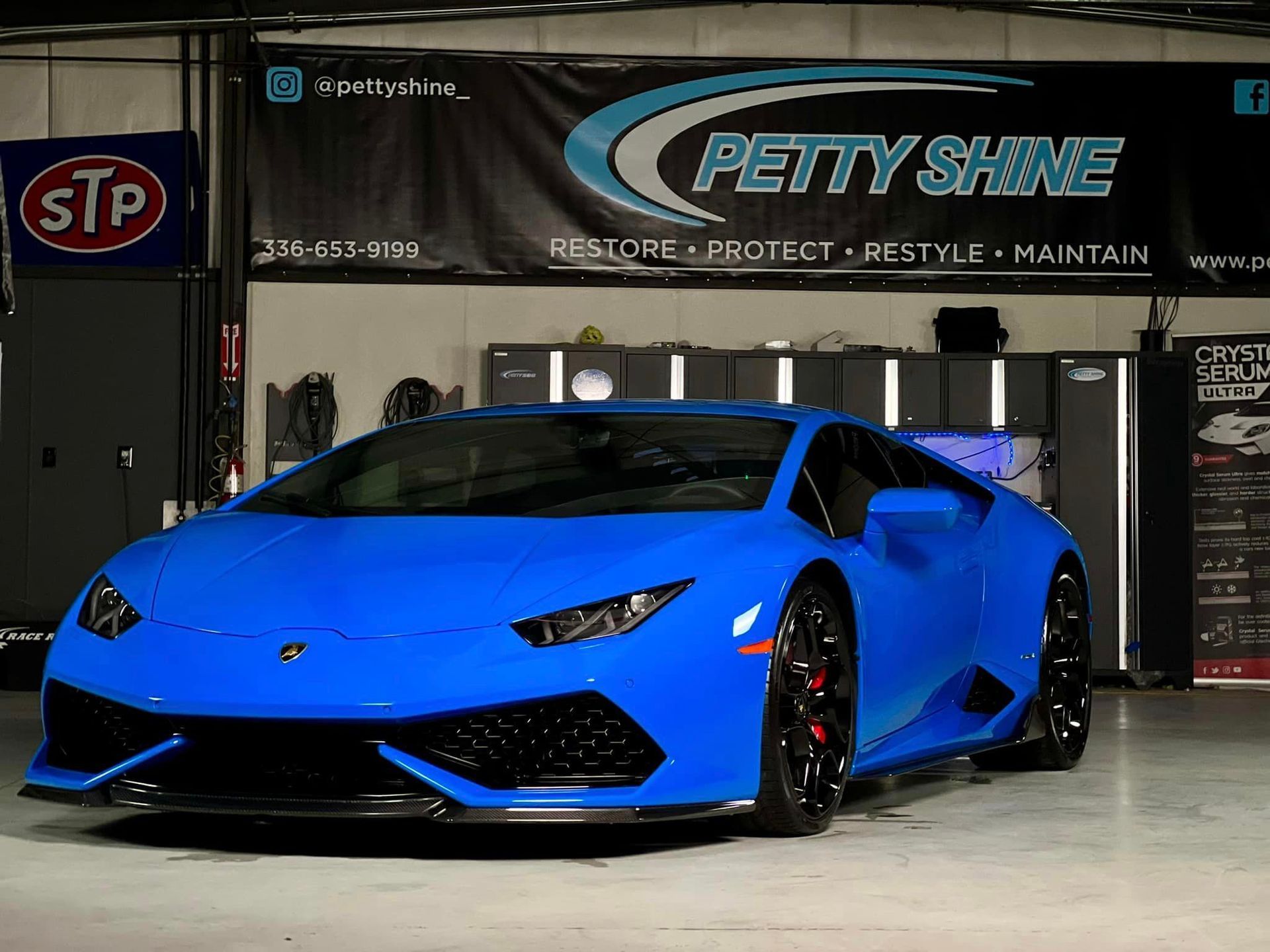 Blue Lamborghini sports car in a garage with 