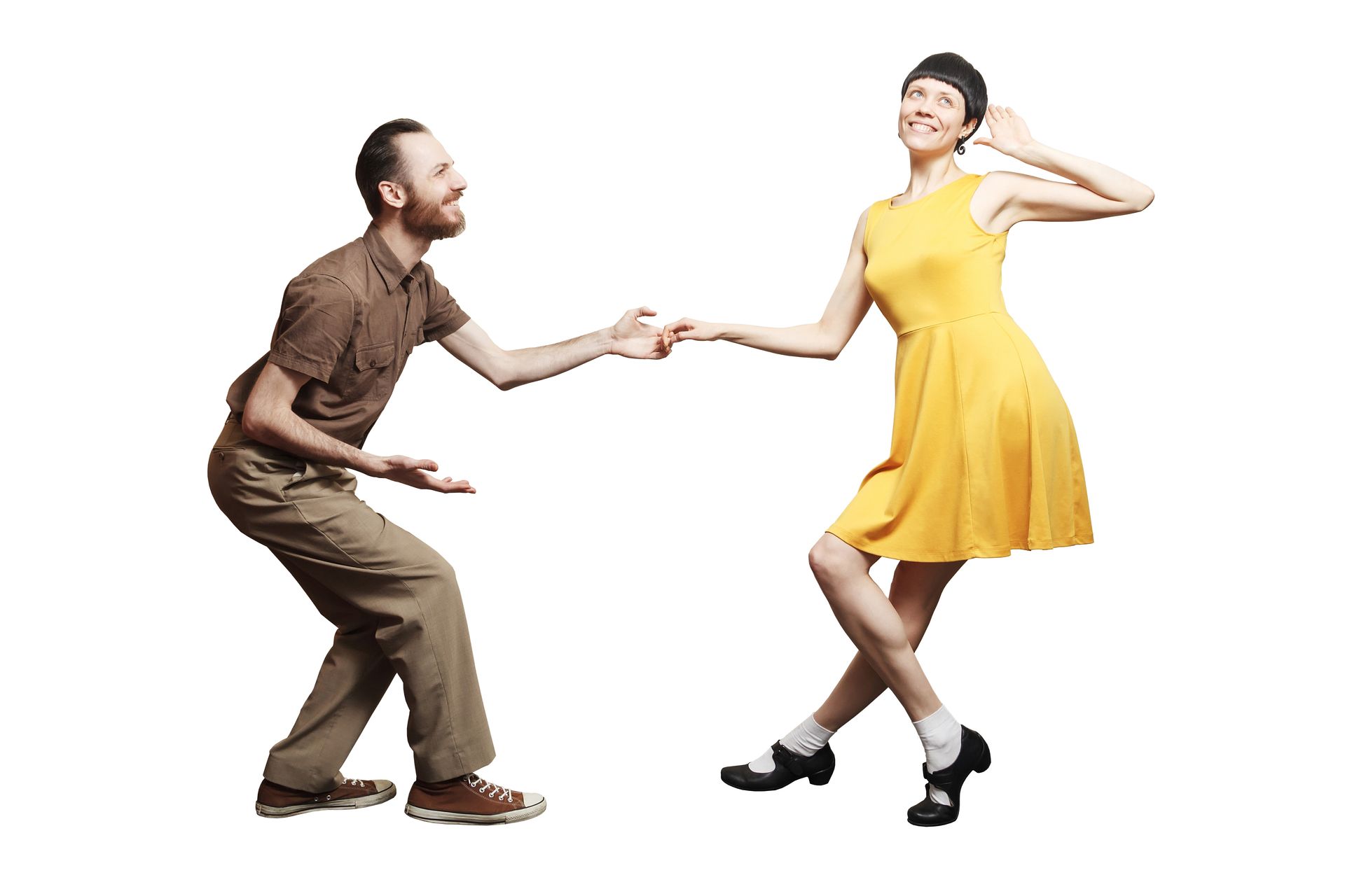 Man and woman swing dancing; he smiles, she looks up; yellow dress, brown shirt.