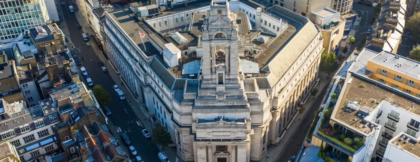 An aerial view of a large building in the middle of a city.