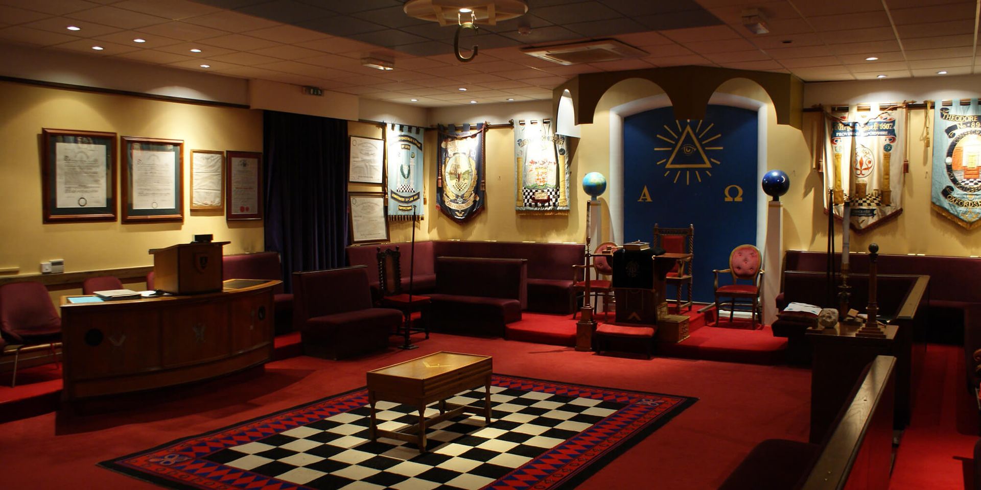 A room with a masonic symbol on the wall