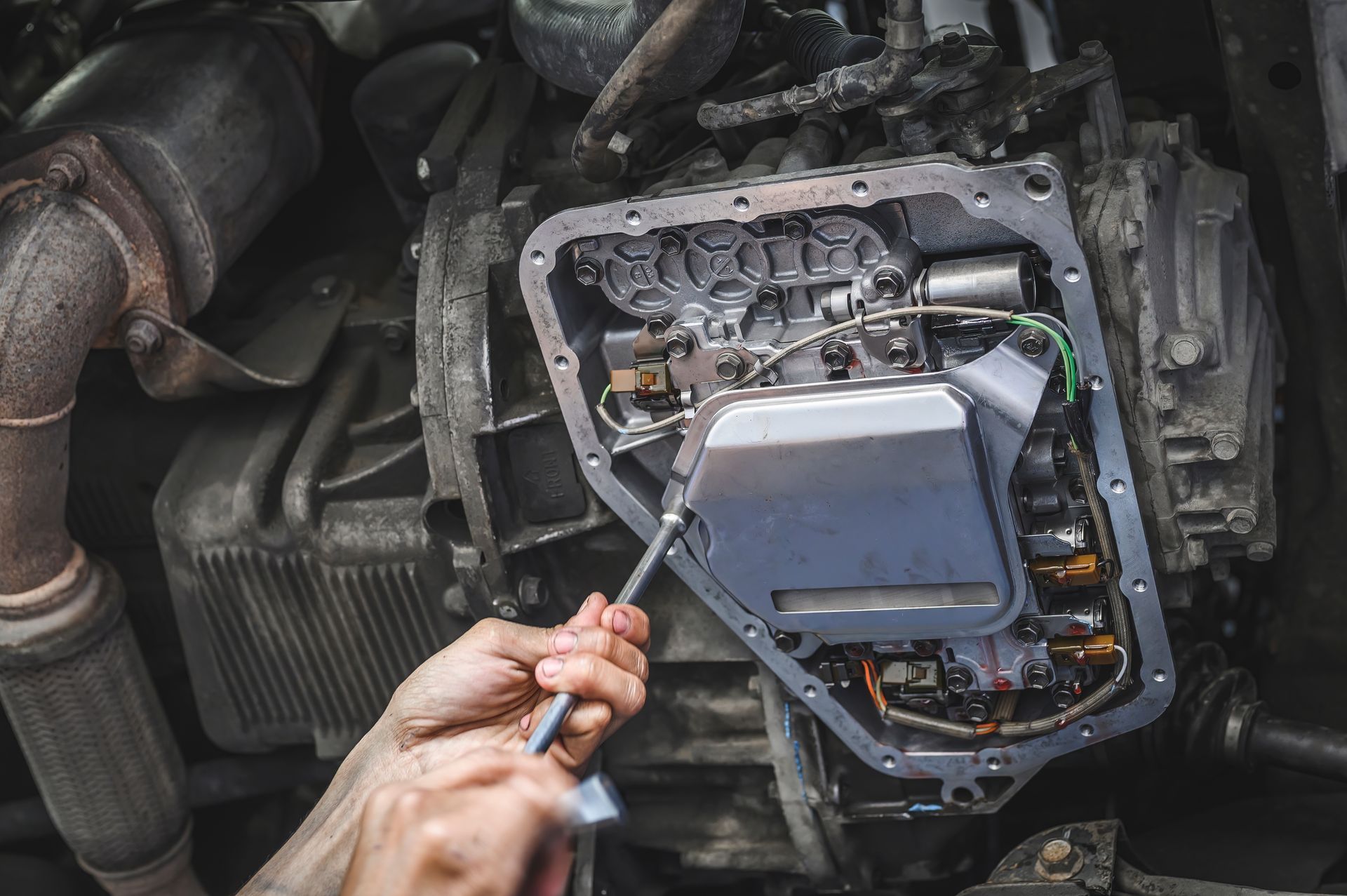 Close-up of a mechanic installing an automatic transmission filter.