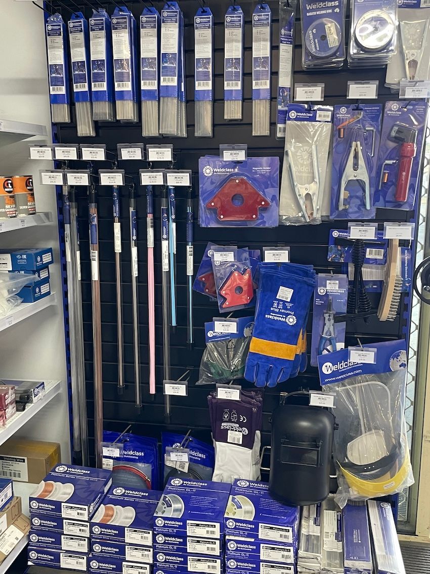Welding supplies on a retail display. Includes rods, gloves, masks, clamps, and magnetic holders -— Shed Constructions (QLD) In Gin Gin, QLD