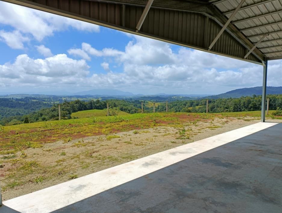 A Large Covered Area With A View Of A Field And Mountains — Shed Constructions (QLD) In Gin Gin, QLD