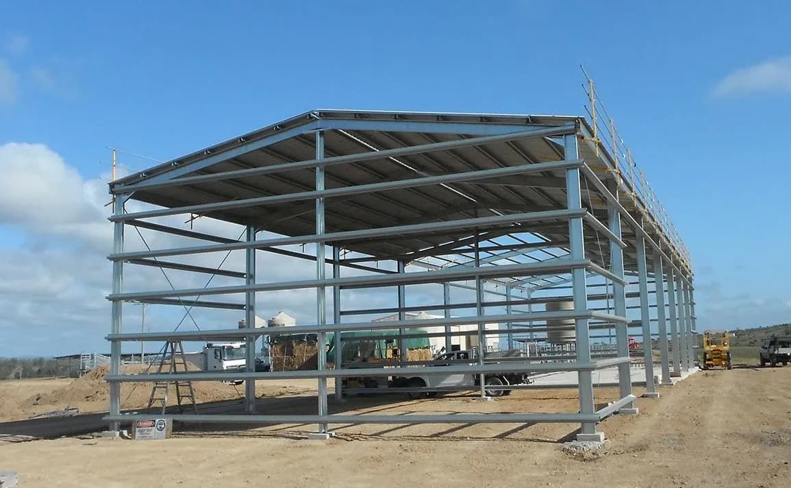 A Large Metal Structure Is Being Built In The Middle Of A Dirt Field — Shed Constructions (QLD) In Gin Gin, QLD
