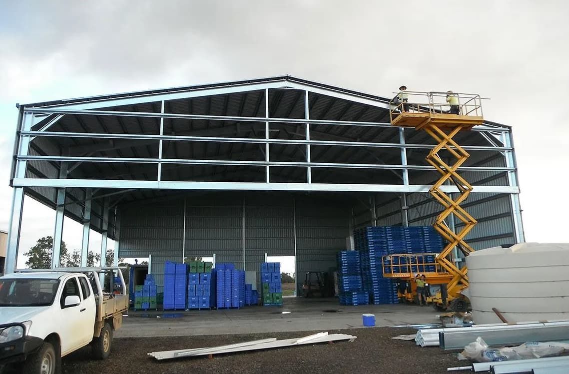 A White Truck Is Parked In Front Of A Building Under Construction — Shed Constructions (QLD) In Gin Gin, QLD