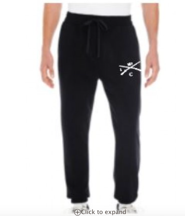 A man is wearing a pair of black sweatpants with a crossbones design on them.