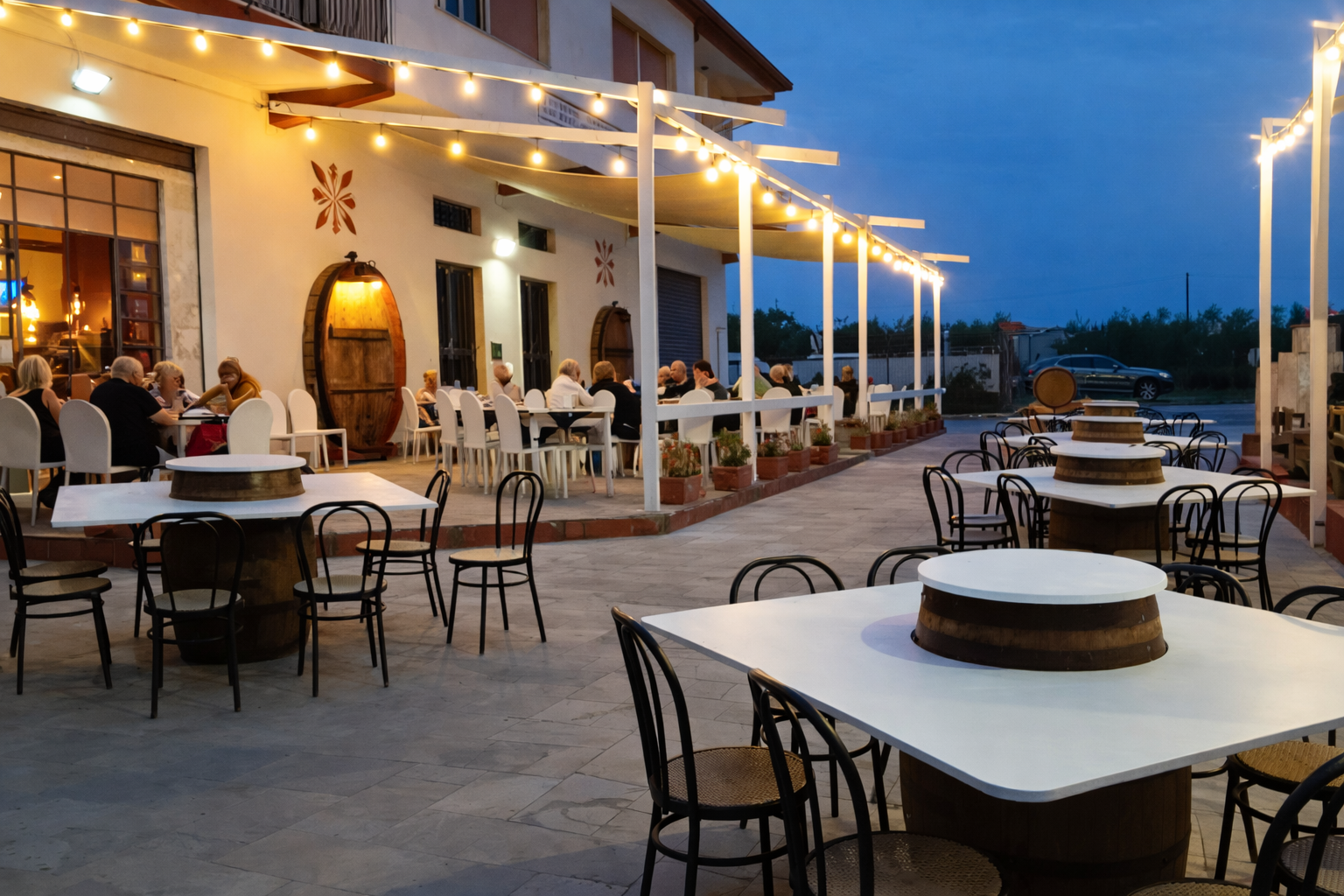 Interno del ristorante con tavoli, sedie e lampade. Decorazioni murali.