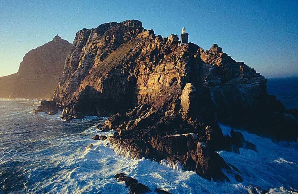 A small island with a lighthouse on top of it