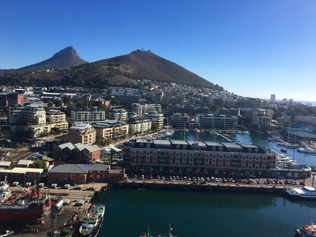 An aerial view of a city with a mountain in the background.