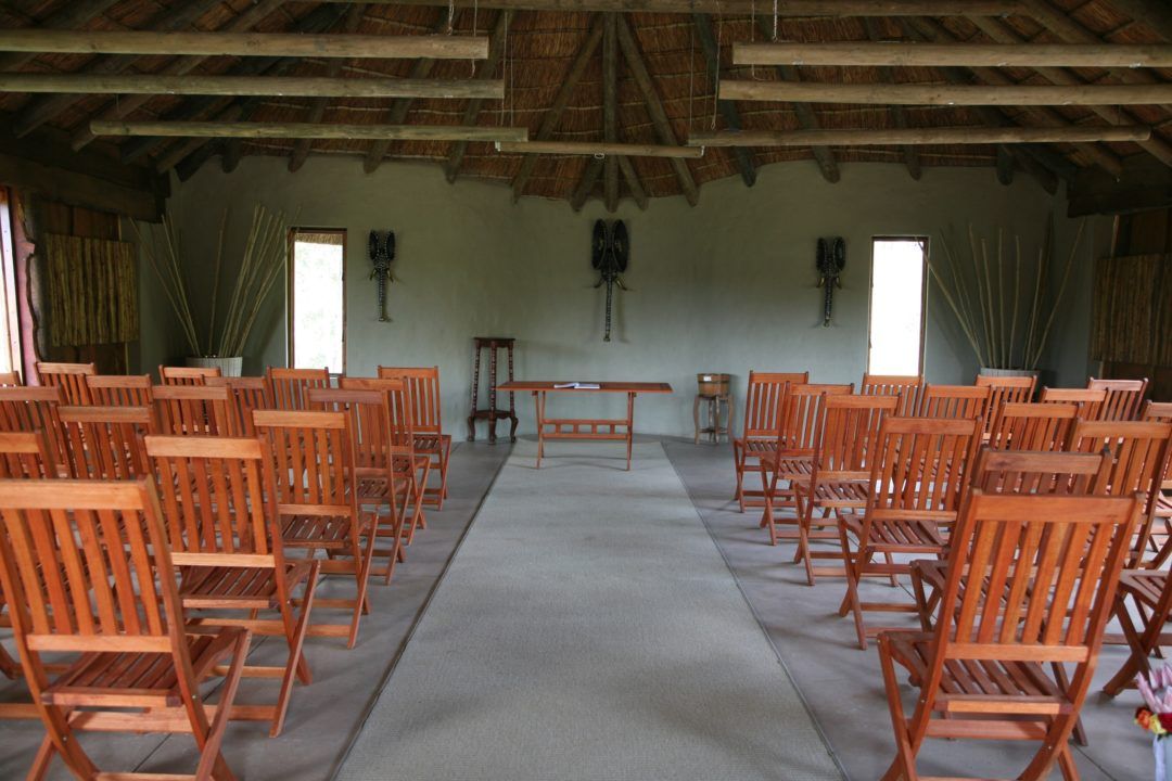 Rows of wooden chairs are lined up in a room