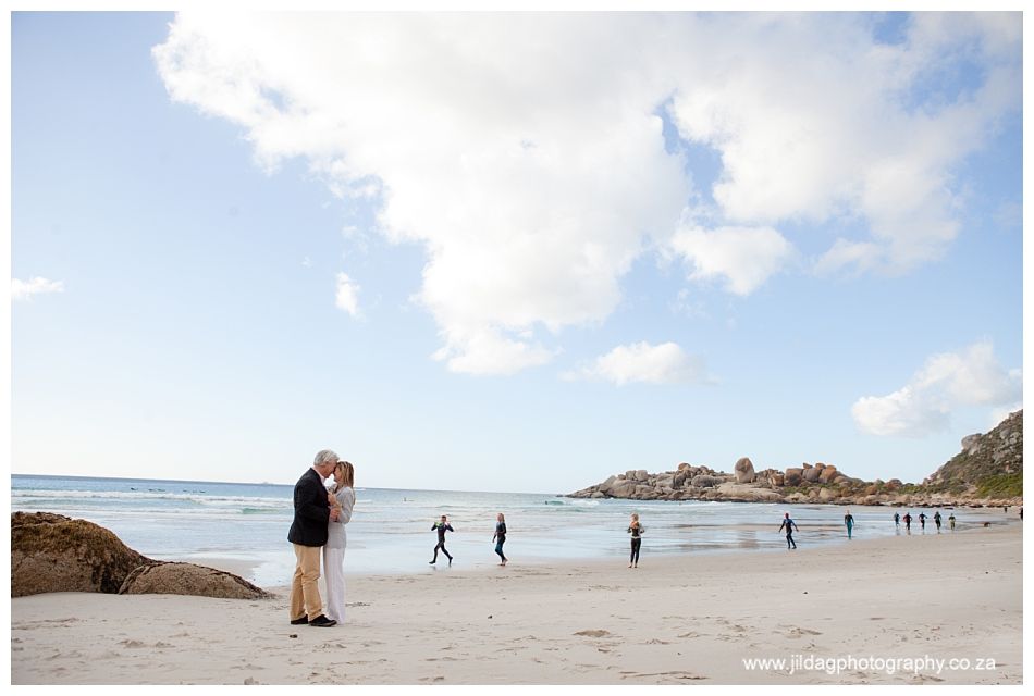 A man and a woman kissing on a beach