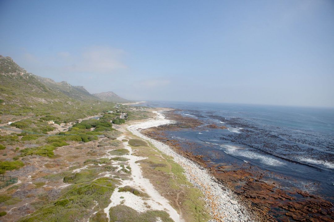 An aerial view of a cliff overlooking the ocean.