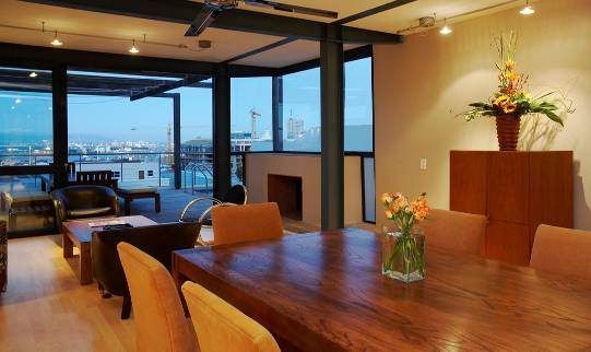 A dining room table with a vase of flowers on it