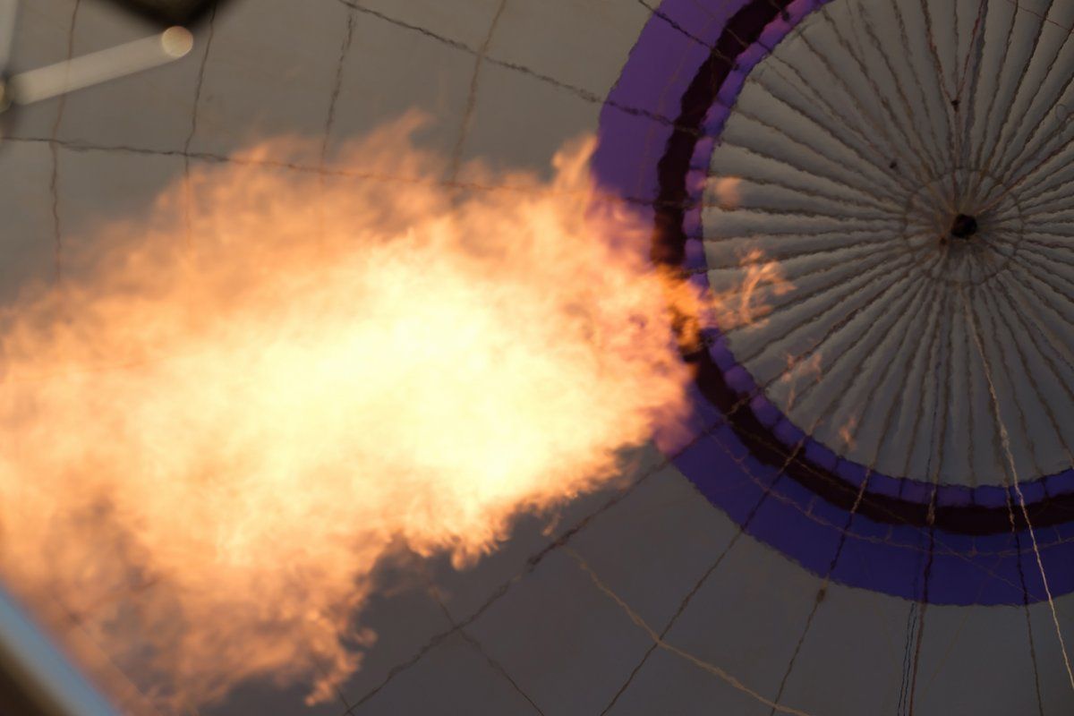 A hot air balloon with flames coming out of it