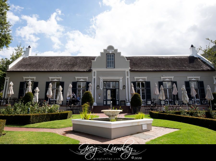 A large house with a fountain in front of it