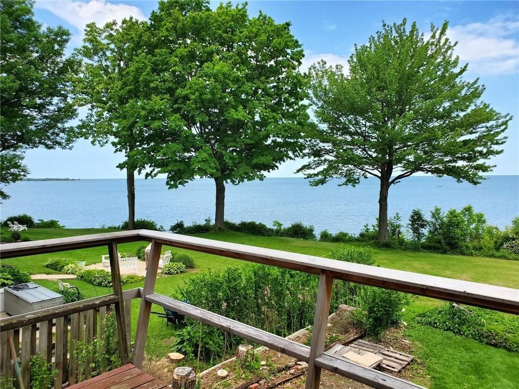 A kitchen with white cabinets and a large island in the middle.