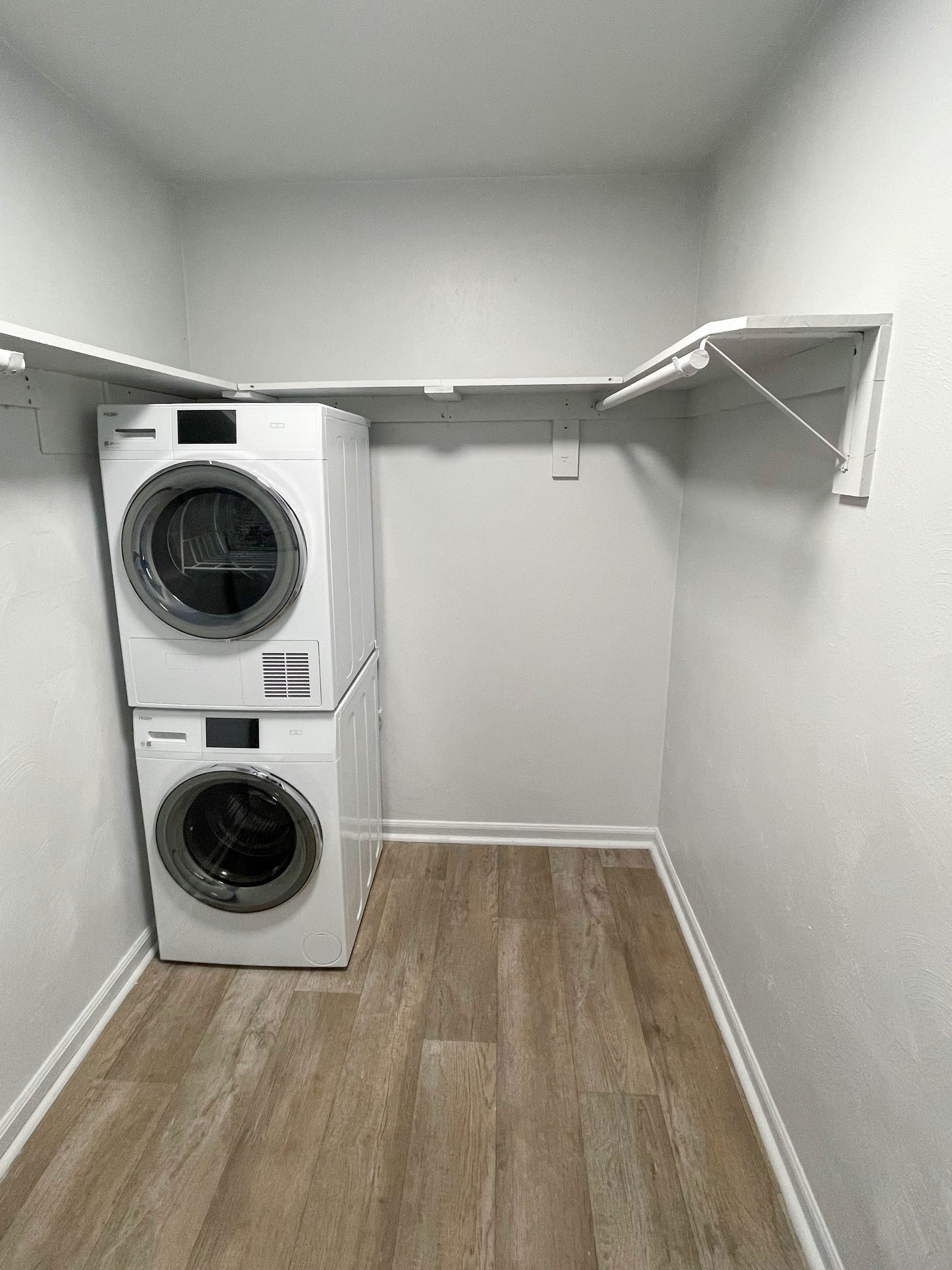 A laundry room with a washer and dryer stacked on top of each other.