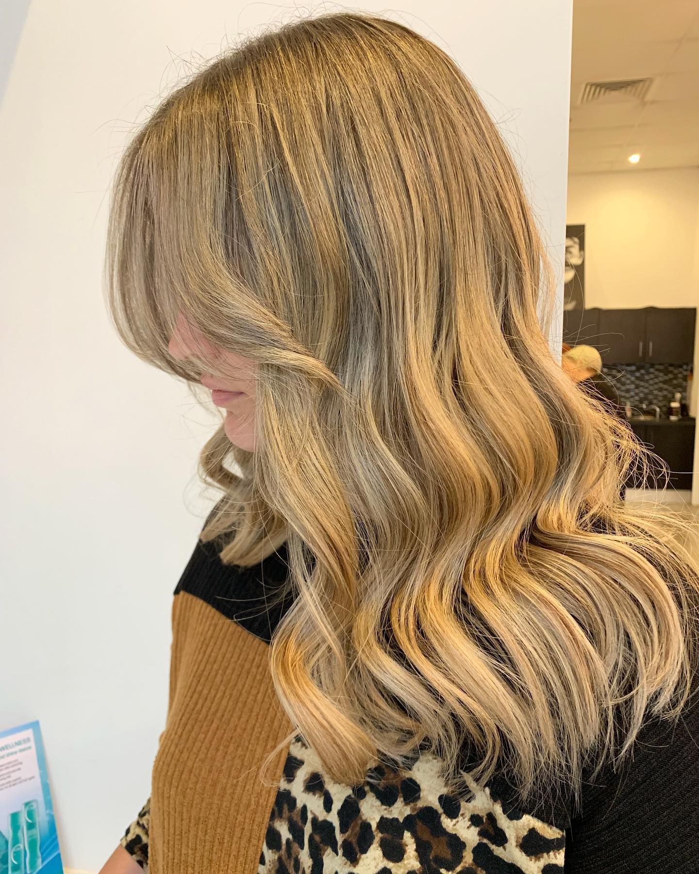Woman With Blonde Highlighted Wavy Hair — Artistry Of Hair in Redlynch, QLD