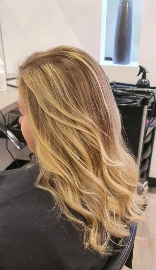 Blonde Hair Styled With Layers and Waves, Showing Highlights and Lowlights — Artistry Of Hair in Redlynch, QLD