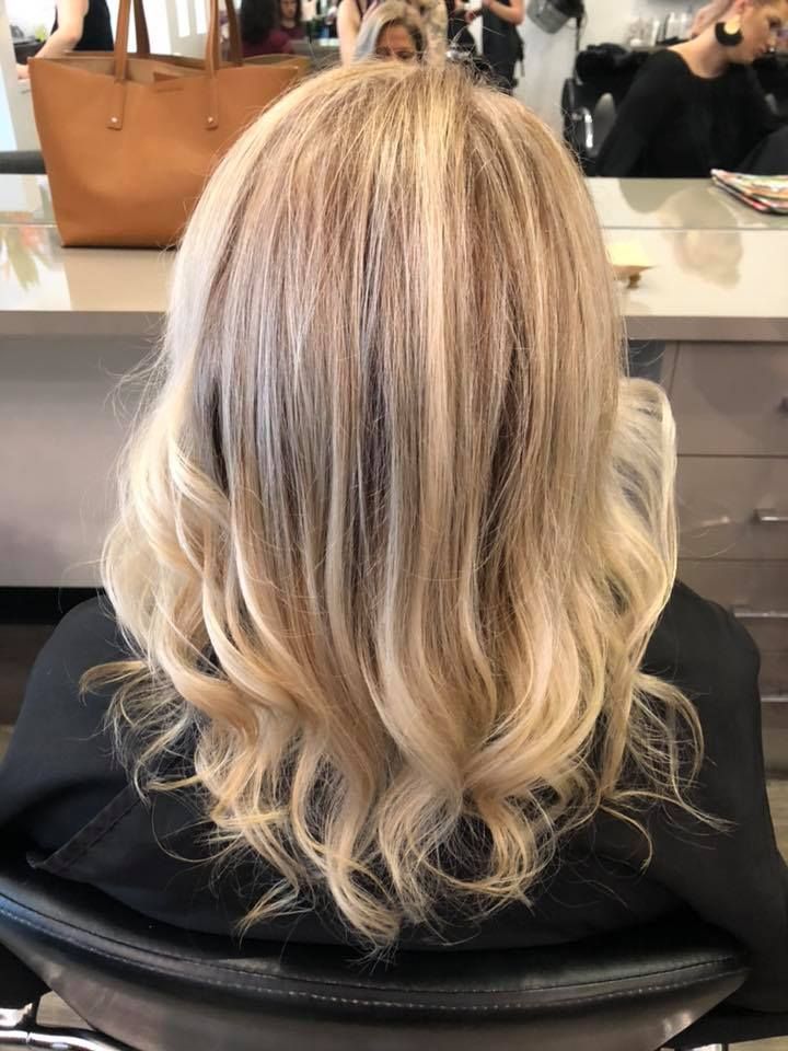 Blonde Hair, Styled With Curls, at a Salon — Artistry Of Hair in Redlynch, QLD