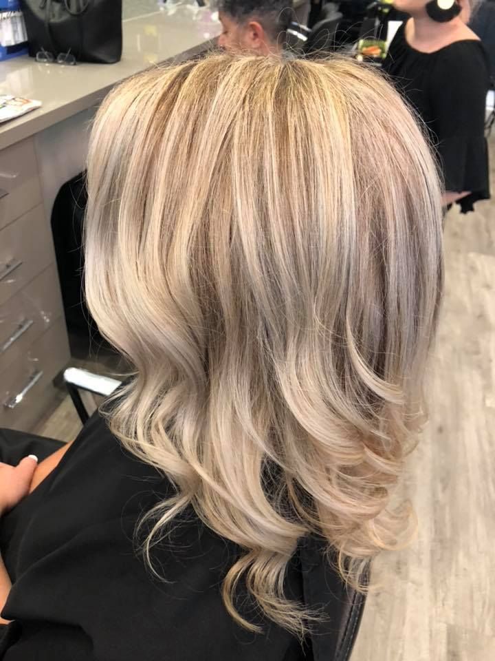 Hairdresser Applying Bleach to Hair in Foils — Artistry Of Hair in Redlynch, QLD