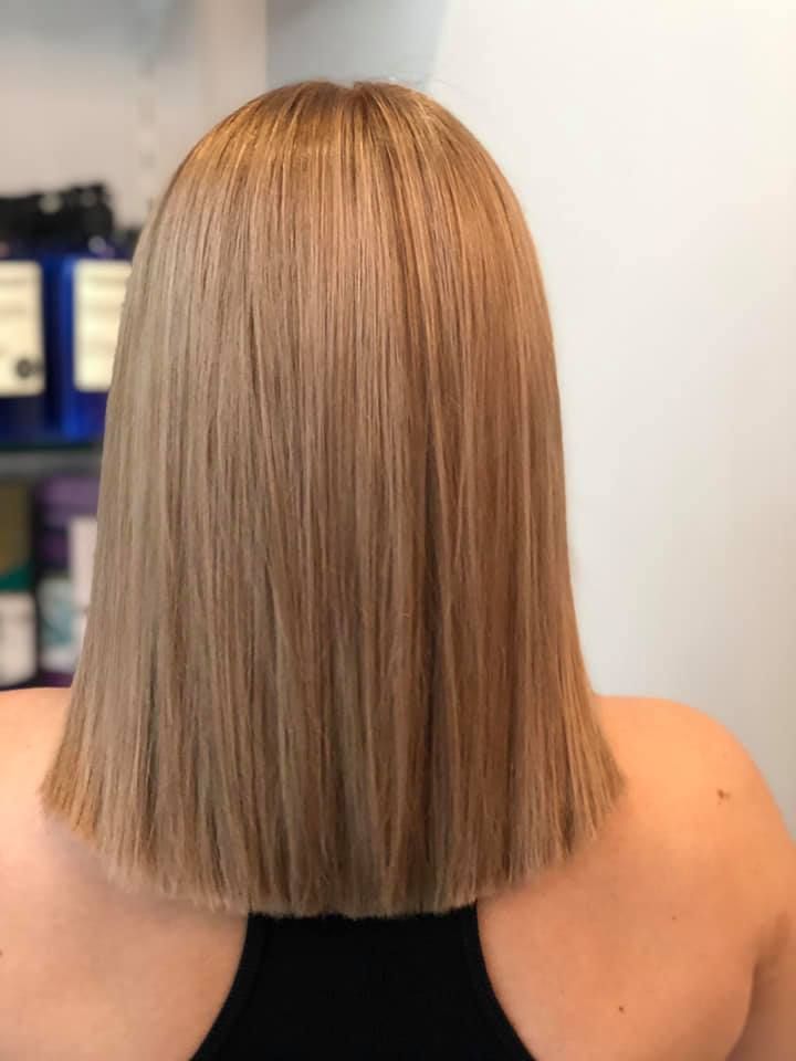 Blonde Hair, Shoulder Length, Sleek Style. Back View of a Person Wearing a Black Top — Artistry Of Hair in Kanimbla, QLD