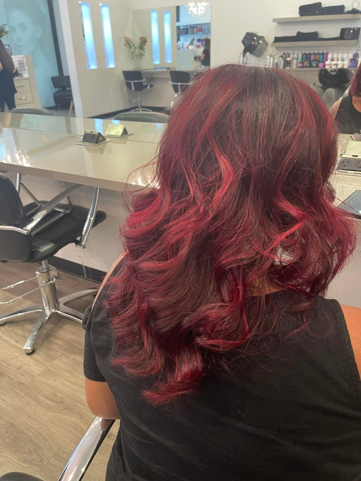 Person With Dark Red Wavy Hair in a Salon Chair — Artistry Of Hair in Redlynch, QLD