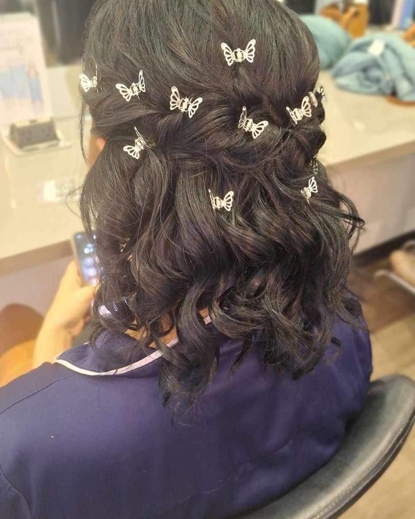 Blonde Hair Styled in a Side Braid With White Flower Hair Accessories — Artistry Of Hair in Redlynch, QLD