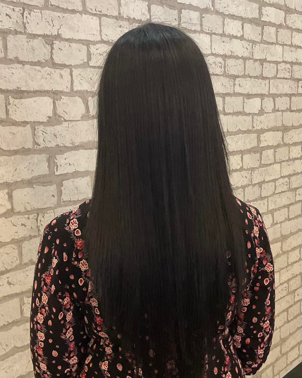 Person With Long, Straight, Black Hair, Wearing a Floral Top — Artistry Of Hair in Redlynch, QLD