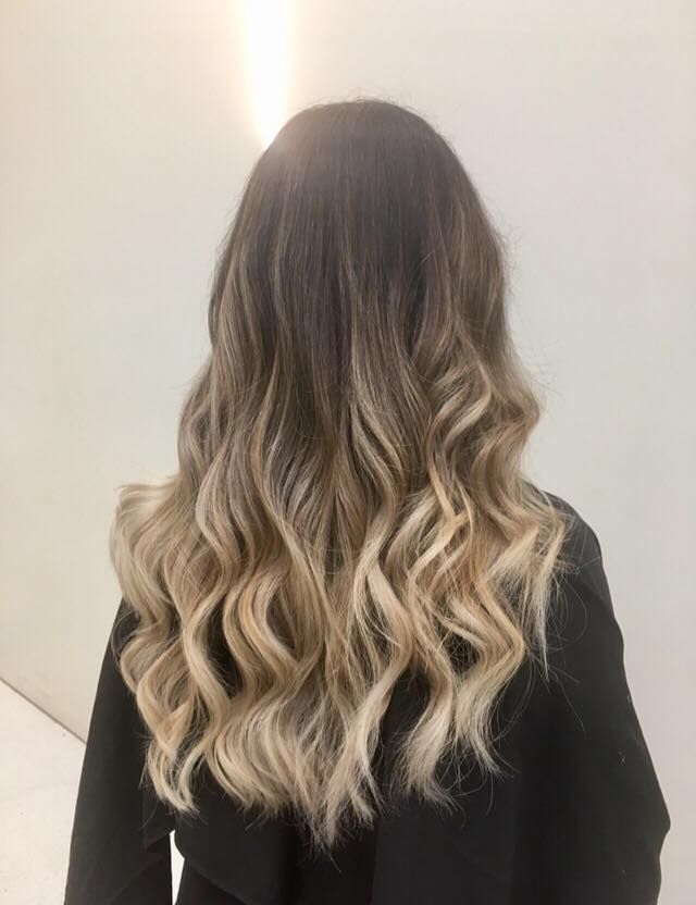 Hair Stylist Cutting Blonde Hair With Scissors and Comb in a Salon — Artistry Of Hair in Kanimbla, QLD