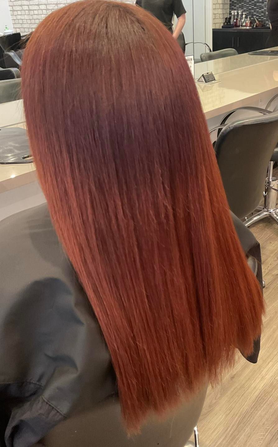 Person With Straight, Red Hair in a Salon Chair, Hair is Long and Vibrant — Artistry Of Hair in Redlynch, QLD