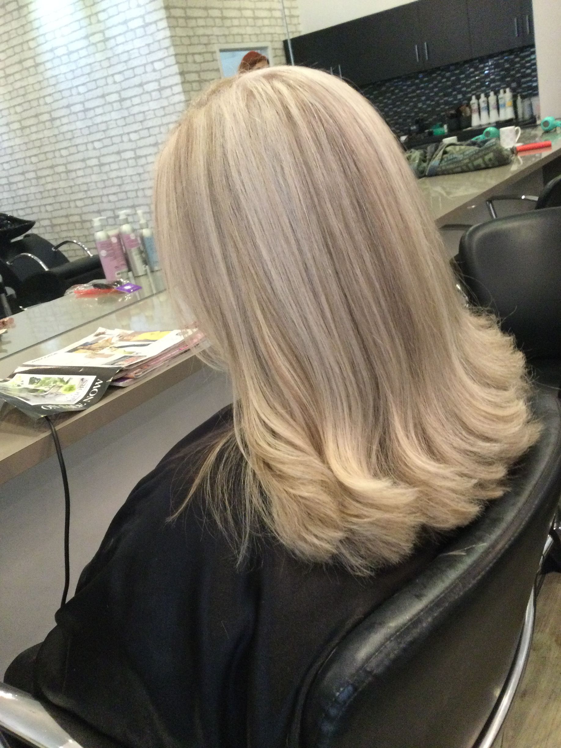 Blonde-haired Person With Styled Curls, Seated in Salon Chair — Artistry Of Hair in Redlynch, QLD