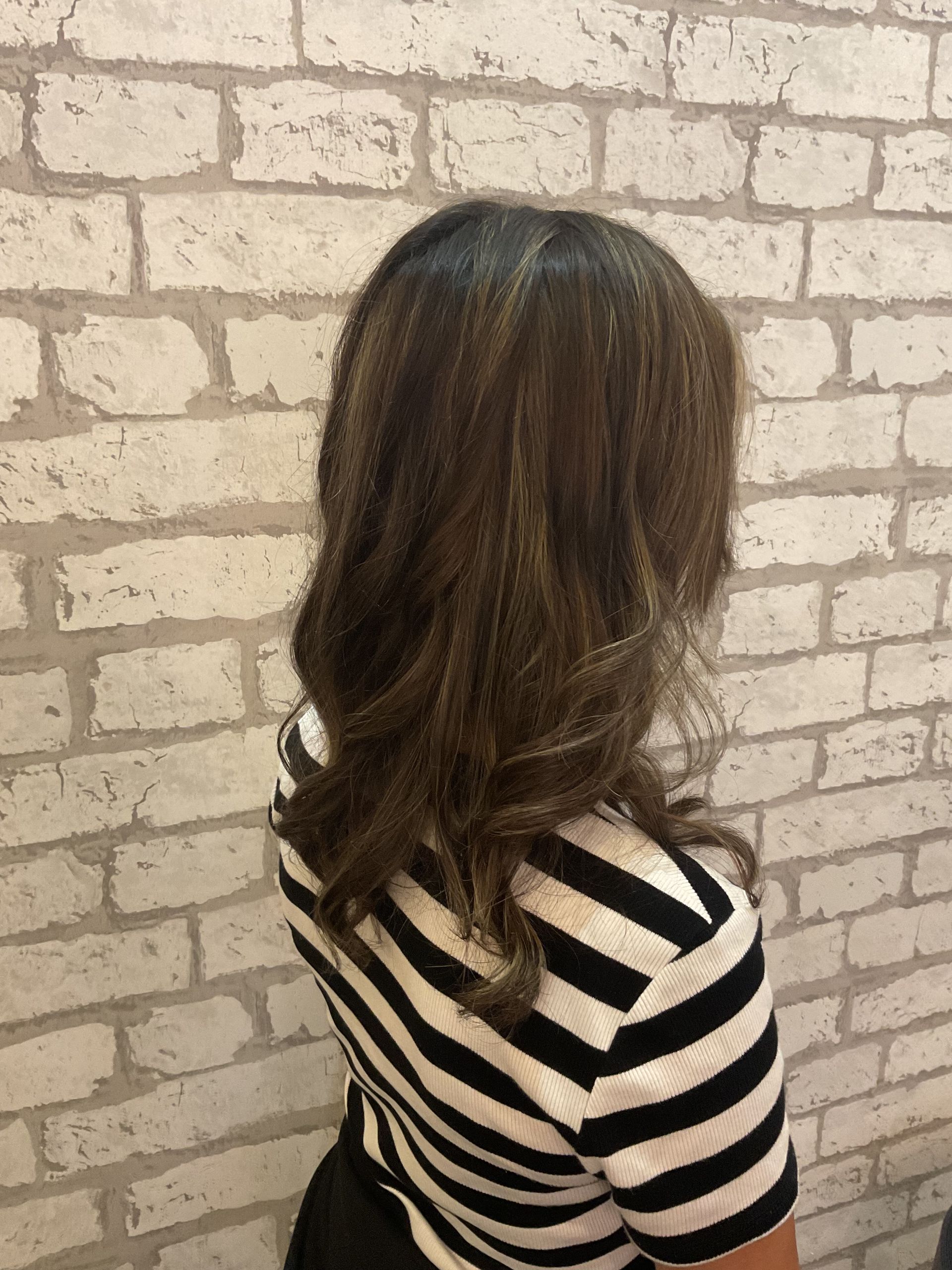 Woman With Wavy, Light Brown to Blonde Hair, Wearing a Black Top — Artistry Of Hair in Redlynch, QLD