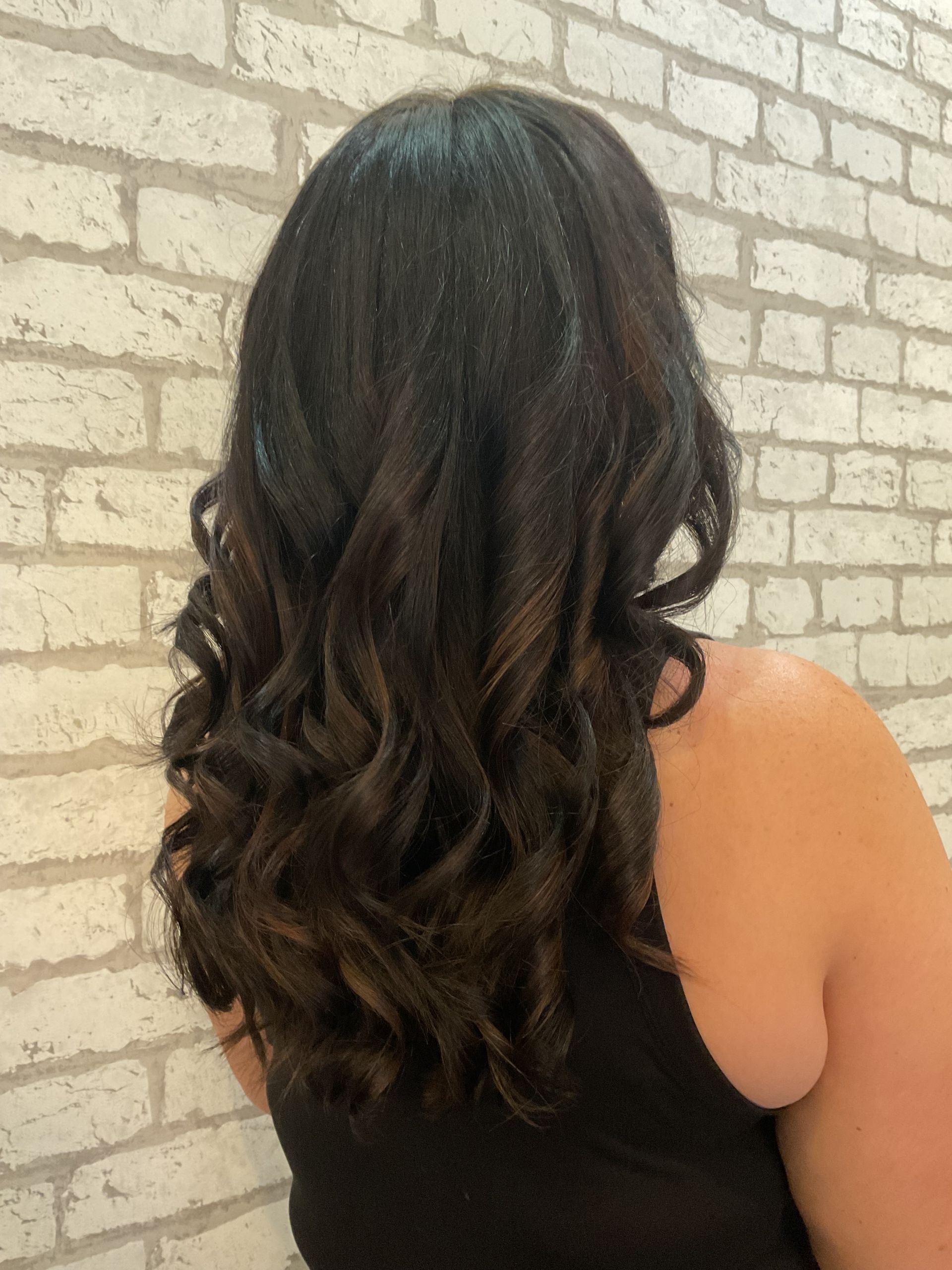 Woman With Layered, Highlighted Brown Hair in a Salon Chair — Artistry Of Hair in Redlynch, QLD