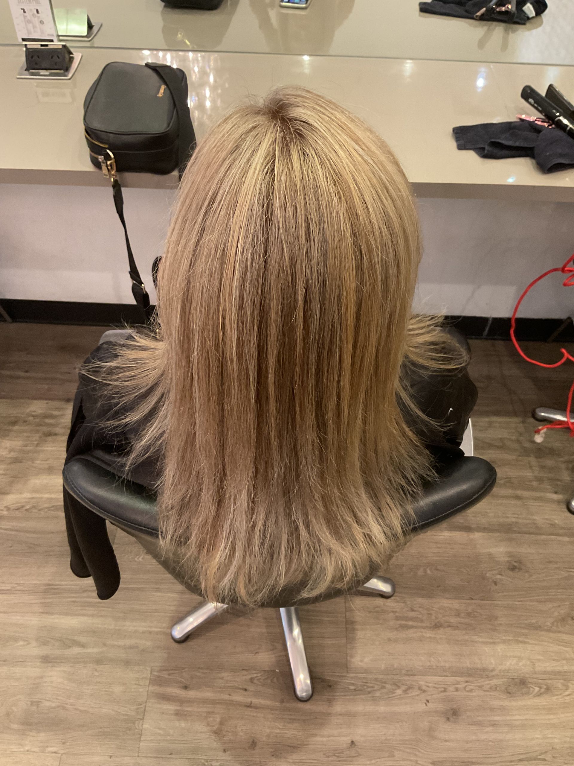 Person With Long, Straight, Burgundy-colored Hair in a Salon — Artistry Of Hair in Redlynch, QLD